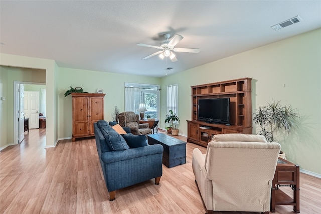 living room with ceiling fan and light wood-type flooring