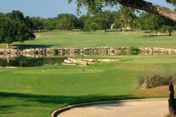 view of home's community with a water view and a lawn