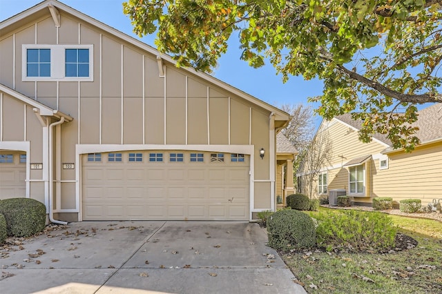 view of front of home with a garage and cooling unit