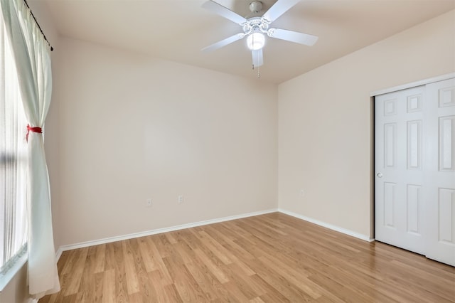 unfurnished bedroom with a closet, light hardwood / wood-style flooring, and ceiling fan