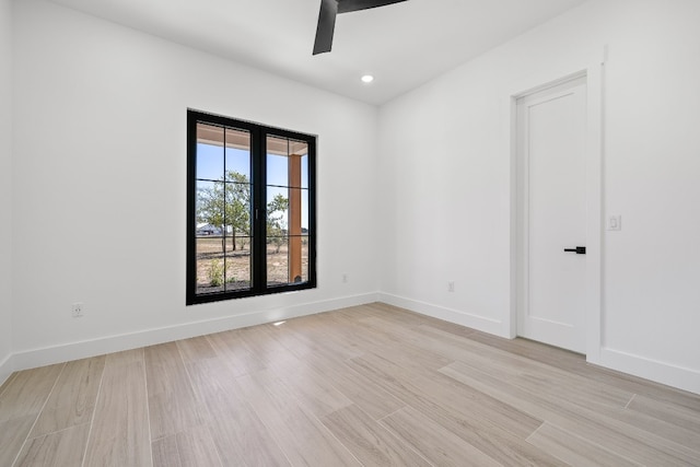 empty room featuring light hardwood / wood-style flooring and ceiling fan