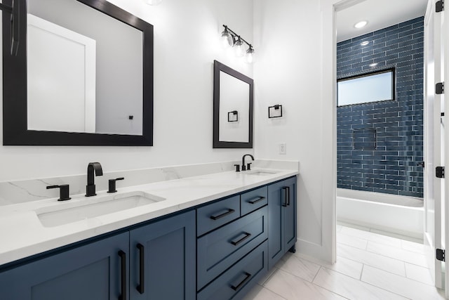 bathroom with vanity and tiled shower / bath