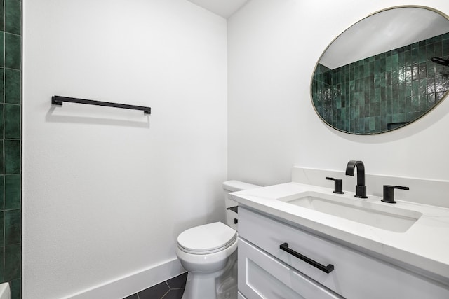 bathroom featuring tile patterned flooring, walk in shower, vanity, and toilet