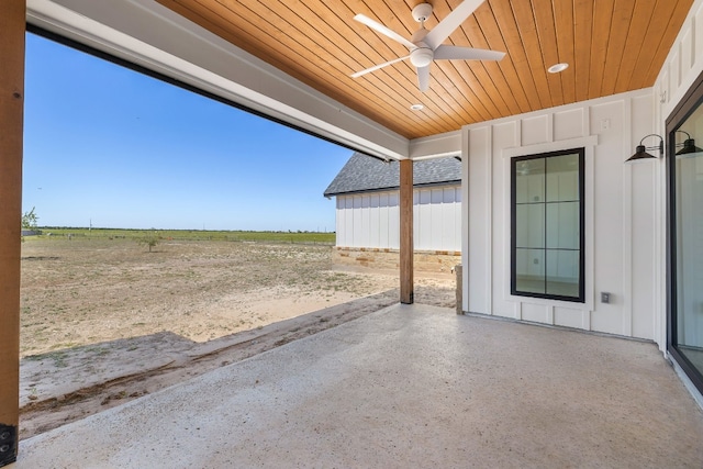 view of patio / terrace featuring ceiling fan and a rural view