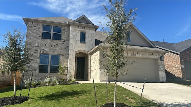 view of front of property featuring a front lawn and a garage