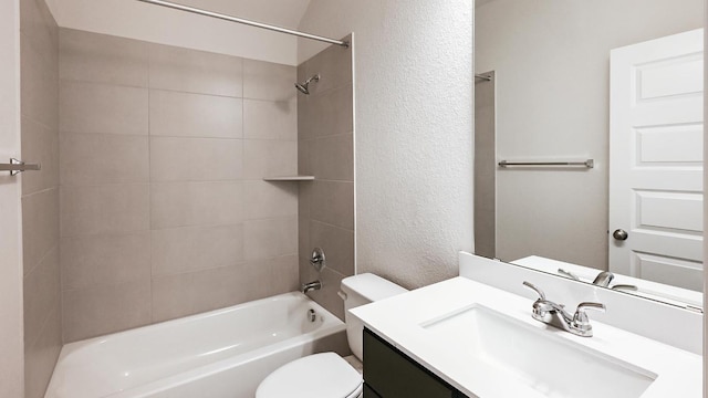 bathroom featuring shower / tub combination, a textured wall, vanity, and toilet