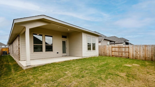 back of house with a patio, a lawn, and fence