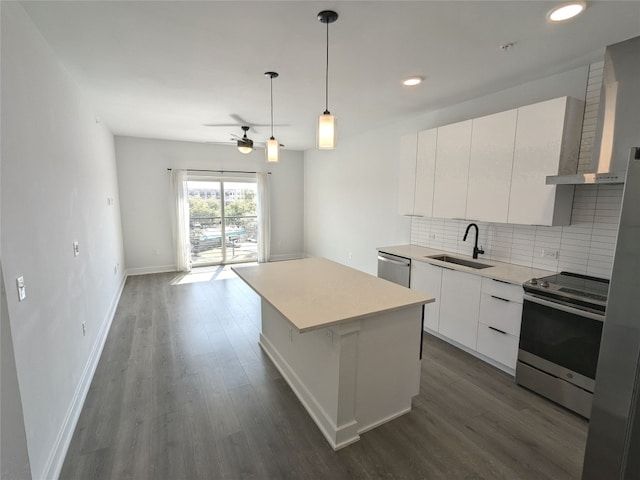 kitchen with ventilation hood, sink, white cabinetry, a kitchen island, and appliances with stainless steel finishes