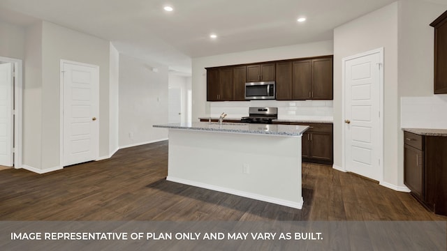 kitchen with a center island with sink, stainless steel appliances, dark hardwood / wood-style floors, and tasteful backsplash