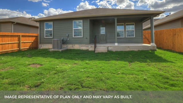 back of property featuring a lawn and central air condition unit