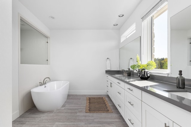 bathroom with a bath and vanity