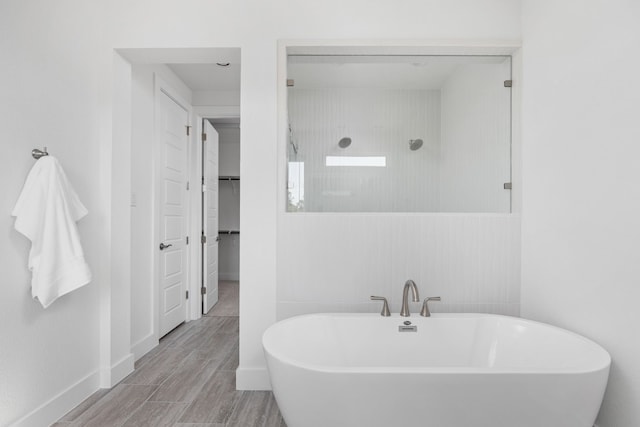 bathroom featuring independent shower and bath