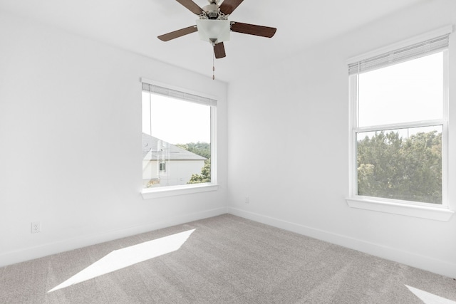 carpeted empty room with ceiling fan and a healthy amount of sunlight