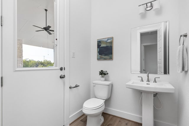 bathroom featuring hardwood / wood-style flooring, toilet, and ceiling fan