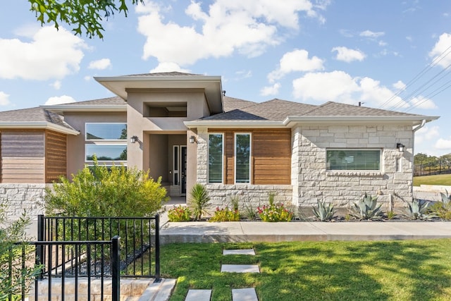 prairie-style house featuring a front lawn