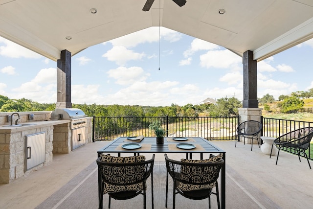 view of patio featuring sink, ceiling fan, exterior kitchen, and a grill