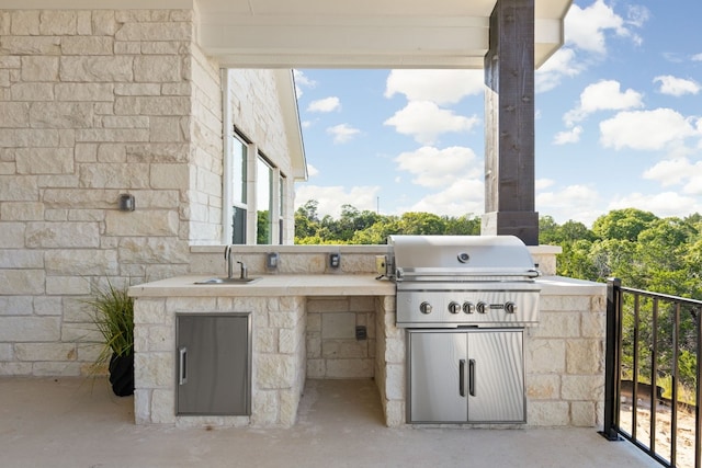 view of patio / terrace with a grill and sink