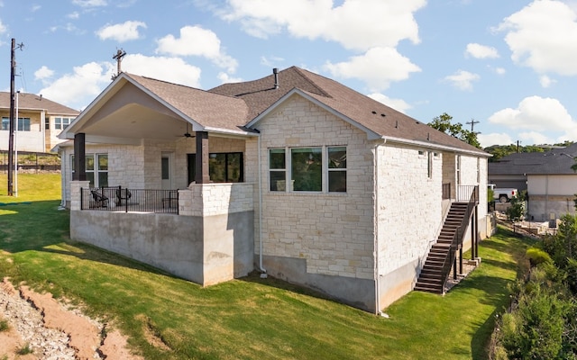 exterior space with a lawn and ceiling fan