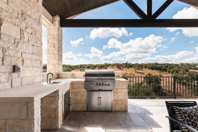 view of patio / terrace featuring exterior kitchen, sink, and a grill