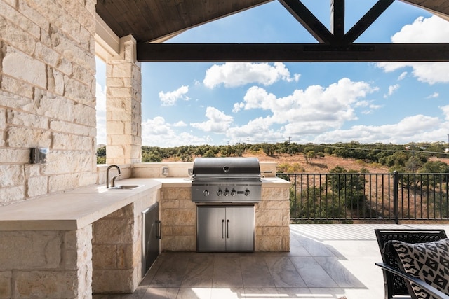 view of patio / terrace featuring an outdoor kitchen, a sink, and grilling area