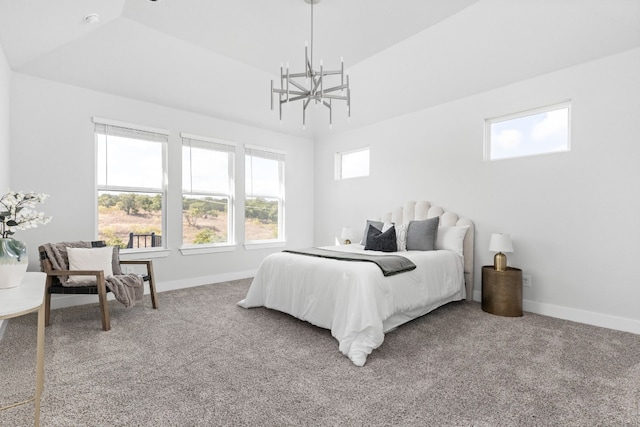 carpeted bedroom with an inviting chandelier and lofted ceiling