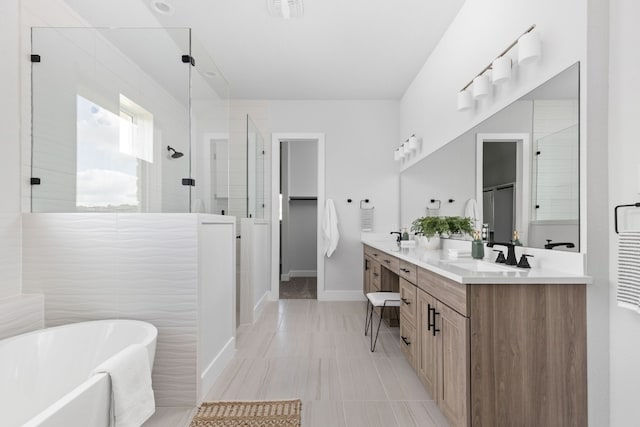 bathroom with vanity and shower with separate bathtub