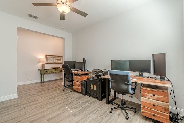 home office featuring light hardwood / wood-style flooring and ceiling fan