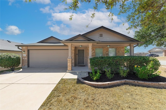 view of front of home with a porch, a garage, and a front lawn