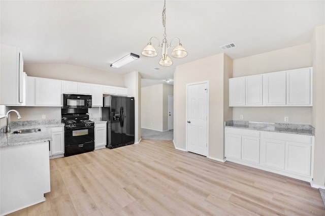 kitchen with light hardwood / wood-style floors, sink, white cabinets, black appliances, and decorative light fixtures