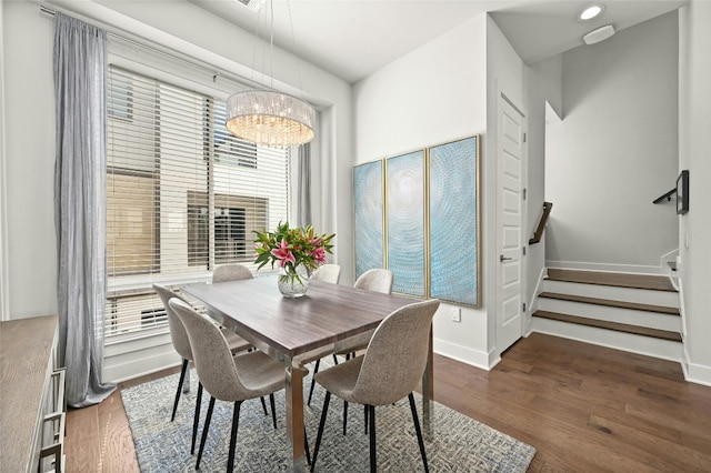 dining room with a notable chandelier, dark hardwood / wood-style floors, and a healthy amount of sunlight