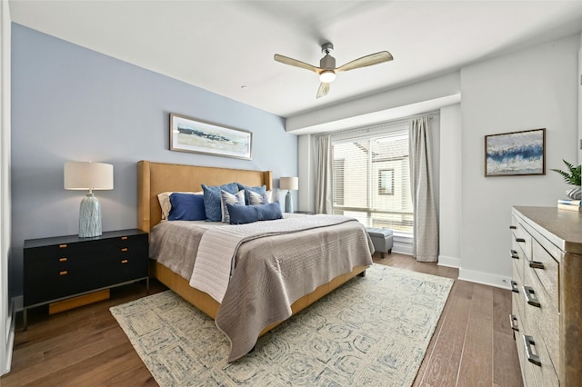 bedroom with ceiling fan and dark hardwood / wood-style flooring