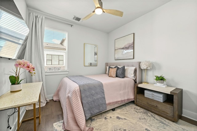 bedroom with wood-type flooring and ceiling fan