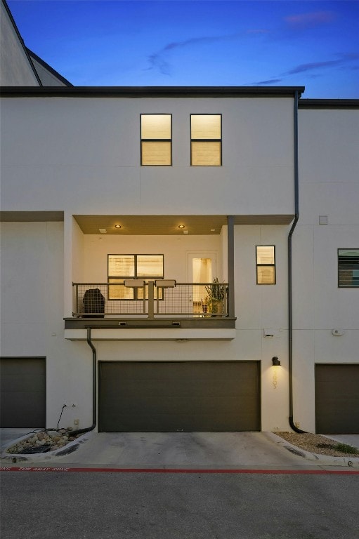 view of front of home featuring a balcony and a garage