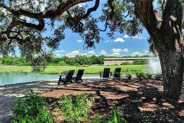 view of home's community featuring a lawn and a water view