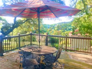 18111 Gregg Bluff Rd, Jonestown, TX 78645 - wooden terrace featuring outdoor dining space