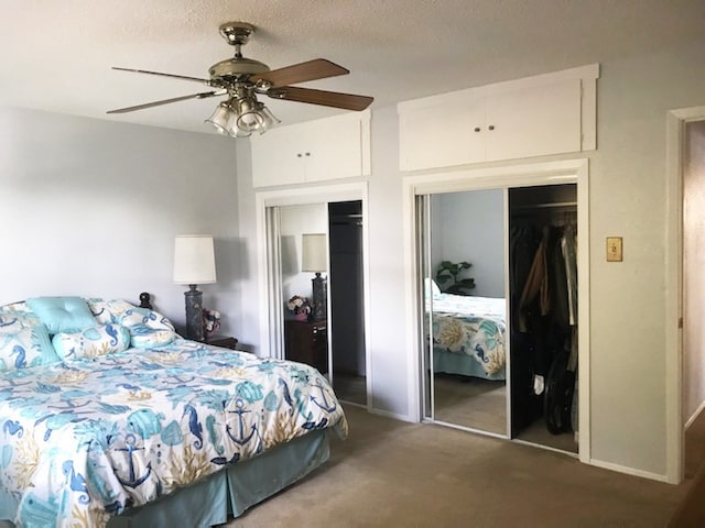 18111 Gregg Bluff Rd, Jonestown, TX 78645 - carpeted bedroom featuring two closets, a ceiling fan, and a textured ceiling