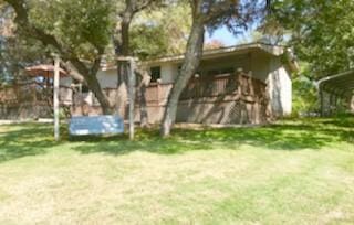 18111 Gregg Bluff Rd, Jonestown, TX 78645 - rear view of house with a detached carport and a lawn