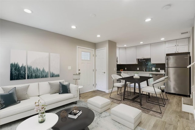 living room with light hardwood / wood-style flooring