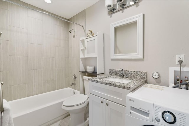 full bathroom with vanity, bathing tub / shower combination, washer / clothes dryer, and toilet