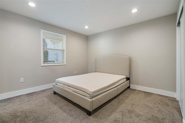 carpeted bedroom featuring recessed lighting and baseboards