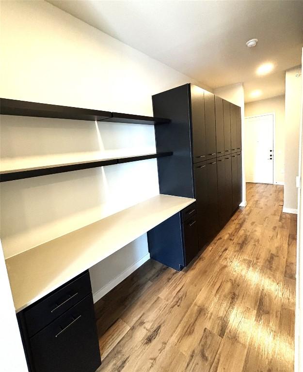 4510 Terry-O Ln Unit 406, Austin, TX 78745 - unfurnished office featuring light wood finished floors, baseboards, and built in desk