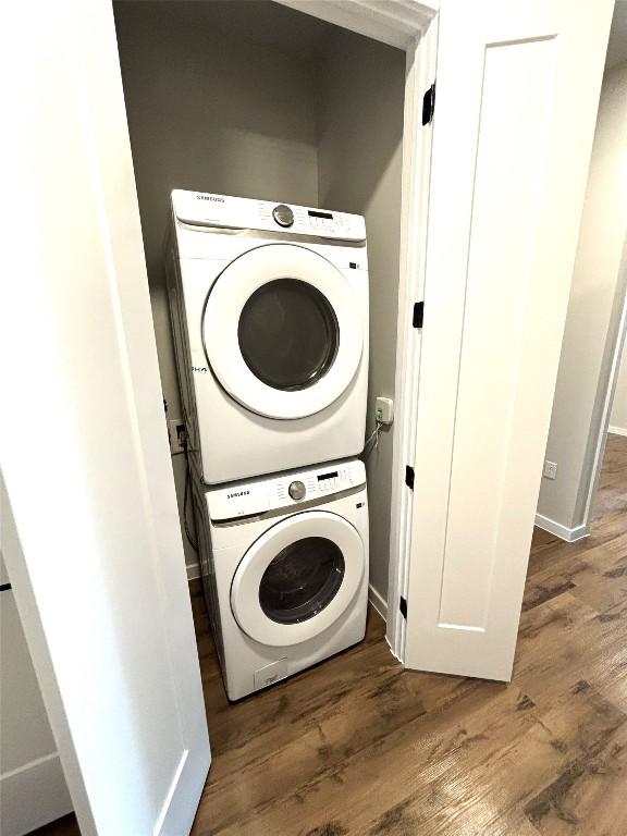 4510 Terry-O Ln Unit 406, Austin, TX 78745 - laundry area with stacked washer / drying machine, wood finished floors, and baseboards