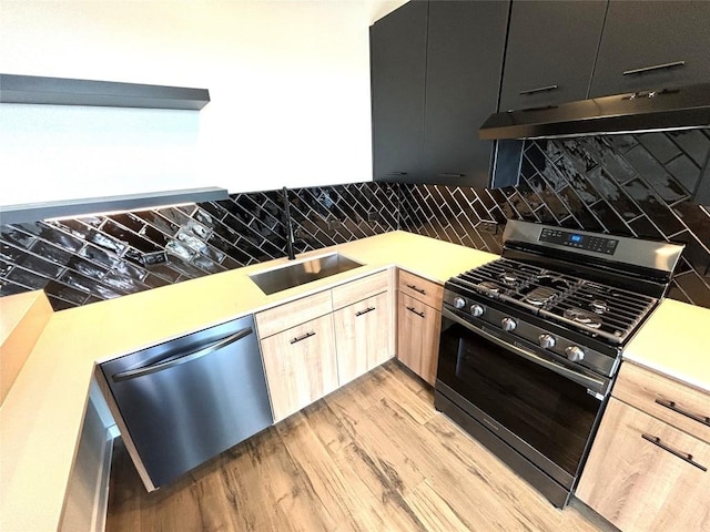 4510 Terry-O Ln Unit 406, Austin, TX 78745 - kitchen with stainless steel appliances, light brown cabinets, light countertops, under cabinet range hood, and backsplash