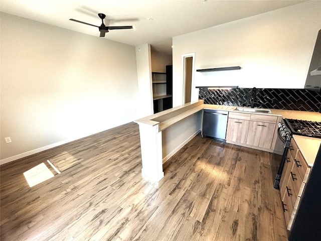 4510 Terry-O Ln Unit 406, Austin, TX 78745 - kitchen with stainless steel dishwasher, a ceiling fan, a peninsula, gas stove, and light countertops