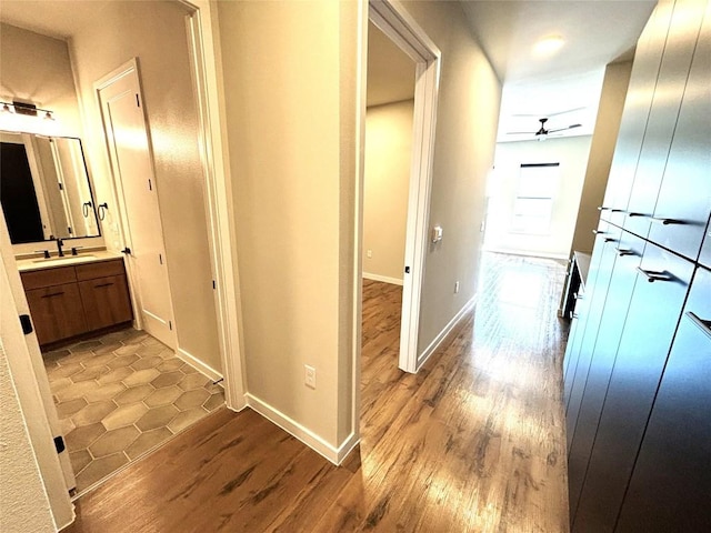 4510 Terry-O Ln Unit 406, Austin, TX 78745 - hallway featuring light wood-style flooring, a sink, and baseboards