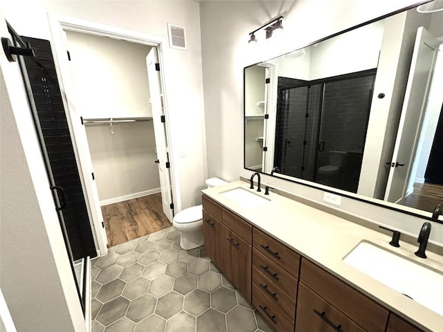 4510 Terry-O Ln Unit 406, Austin, TX 78745 - full bathroom with a shower stall, toilet, tile patterned flooring, double vanity, and a spacious closet