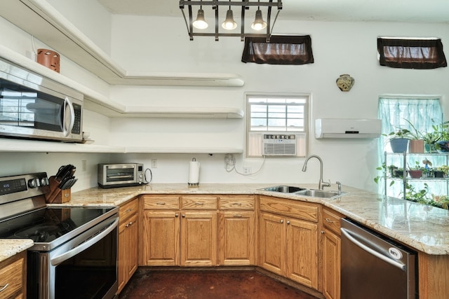 kitchen featuring cooling unit, sink, stainless steel appliances, light stone countertops, and a wall mounted air conditioner