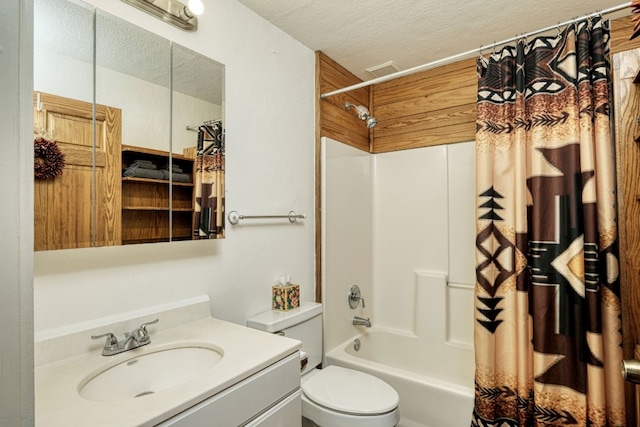 full bathroom with a textured ceiling, shower / tub combo with curtain, vanity, and toilet