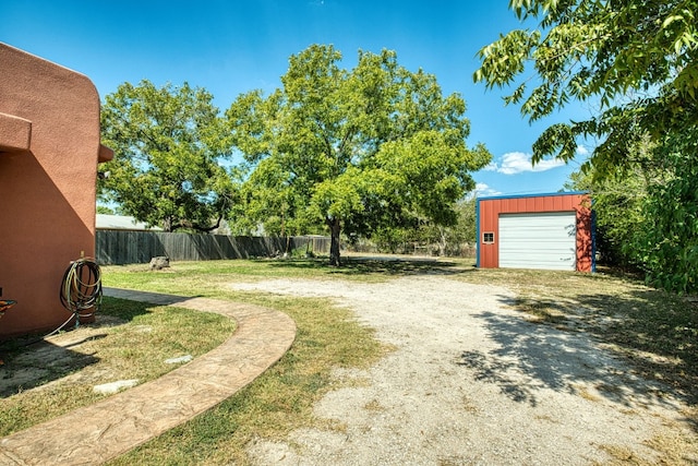 view of yard featuring an outbuilding and a garage