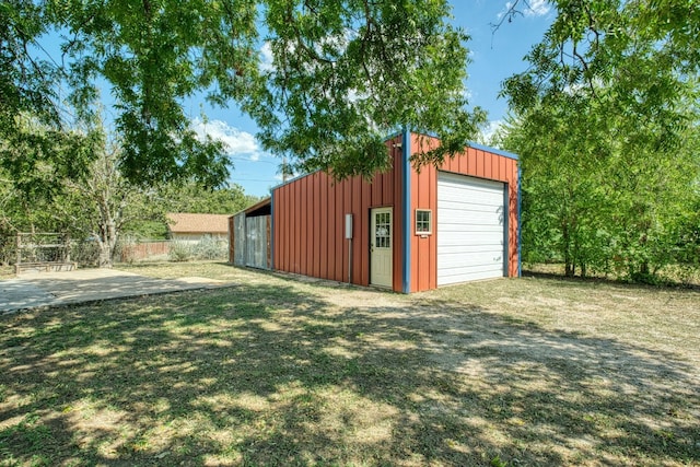 view of outbuilding with a yard and a garage